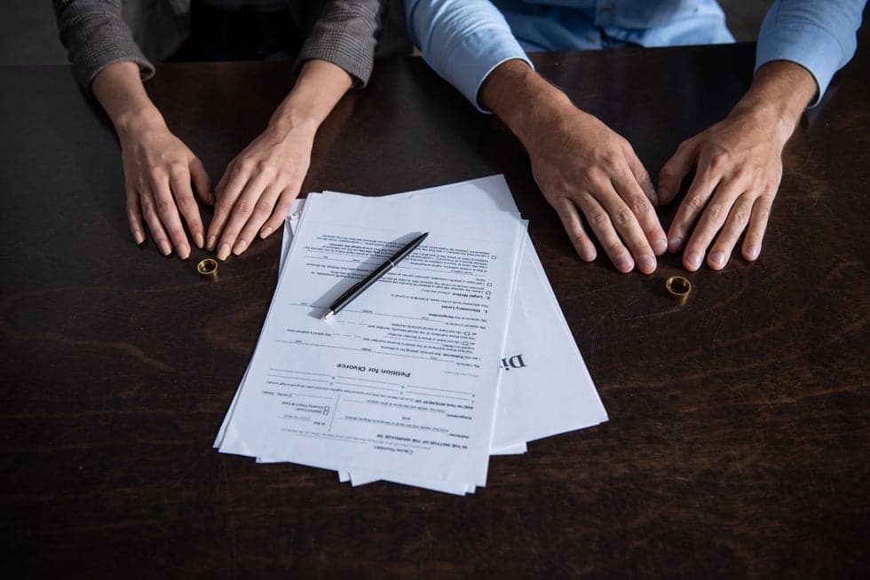 Couple at table with divorce documents