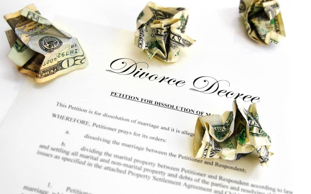 Divorce decree covered in crumpled dollar bills