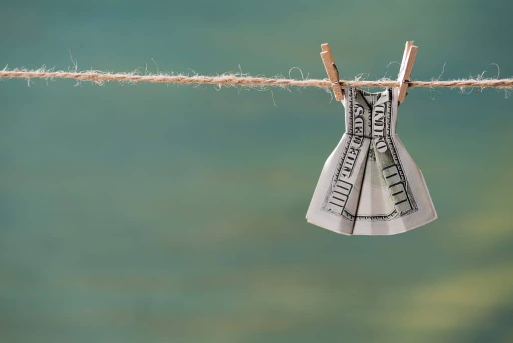 money folded to look like dress hanging on a clothesline