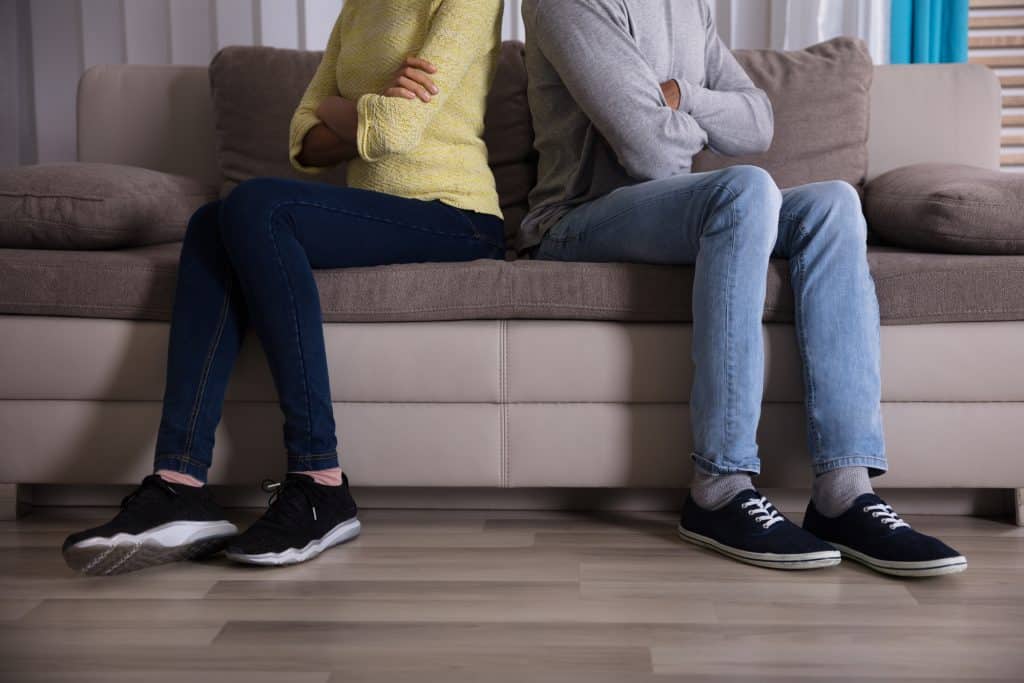 Couple sitting on couch turned away from each other
