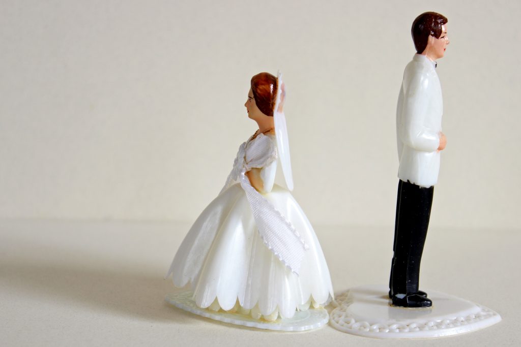 wedding cake topper with bride and groom facing away from each other