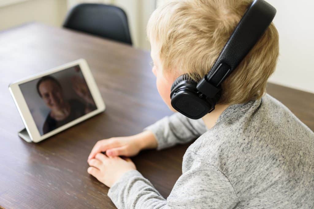 Child having video call to mother using tablet