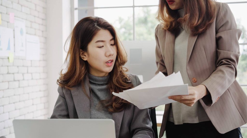 two women talking at work