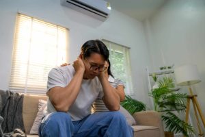 man stressed in home