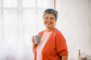 Senior woman holding coffee cup
