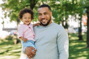 Father holding young son